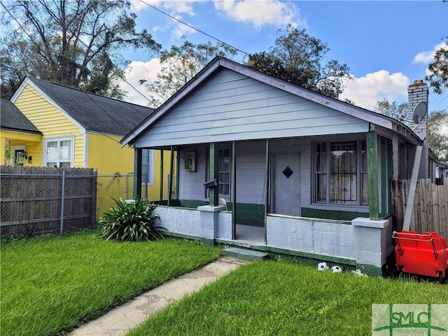 bungalow-style house with covered porch and a front yard