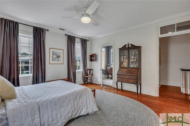 bedroom featuring ornamental molding, hardwood / wood-style flooring, multiple windows, and ceiling fan