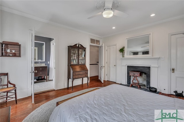 bedroom with ornamental molding, hardwood / wood-style floors, and ceiling fan