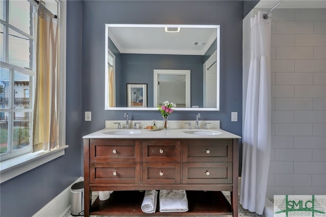 bathroom with ornamental molding, vanity, and a shower with curtain