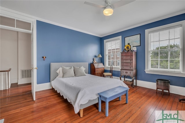 bedroom featuring ornamental molding, ceiling fan, a closet, and wood-type flooring