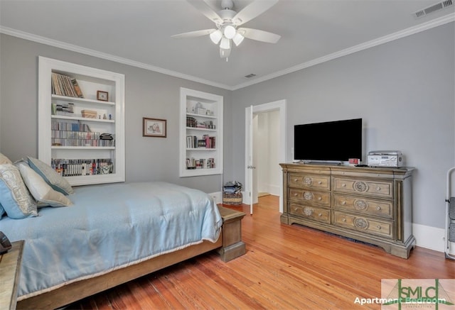 bedroom with hardwood / wood-style flooring, crown molding, and ceiling fan