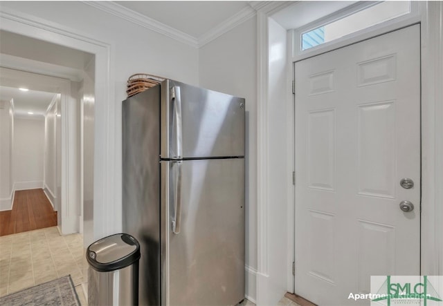 kitchen featuring ornamental molding, stainless steel fridge, and light wood-type flooring