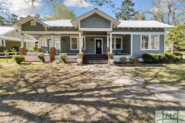 exterior space with a porch and metal roof