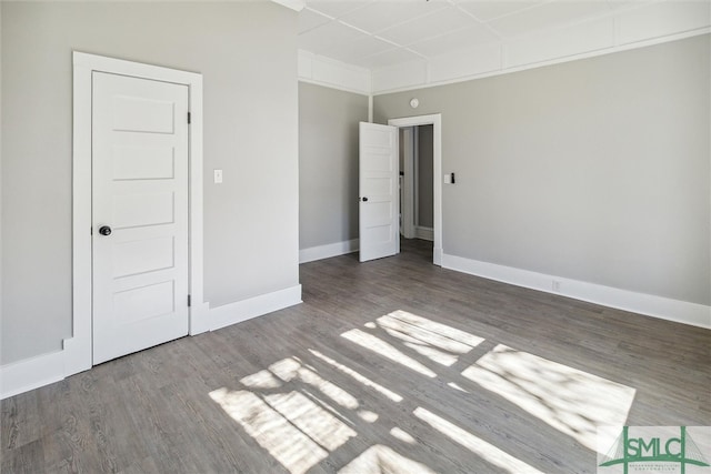 unfurnished bedroom featuring dark hardwood / wood-style floors