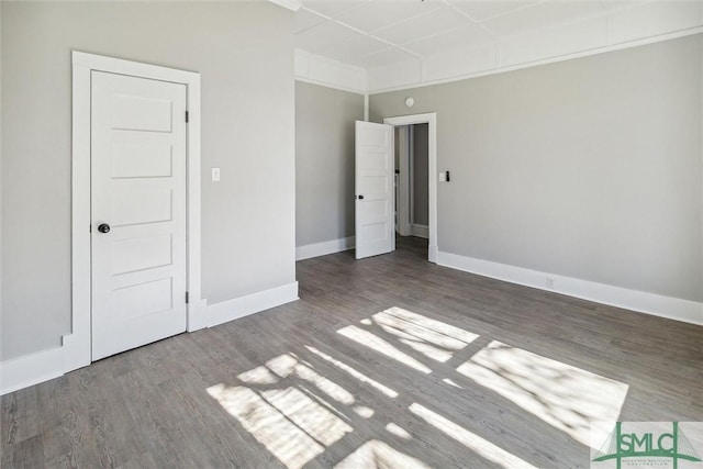 unfurnished bedroom featuring baseboards and wood finished floors