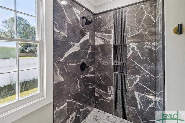 bathroom with ornamental molding, tiled shower, and plenty of natural light