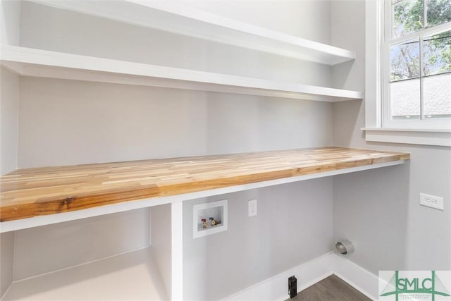 washroom featuring laundry area, baseboards, and hookup for a washing machine