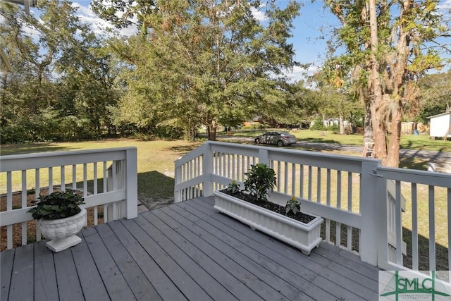 wooden deck featuring a yard