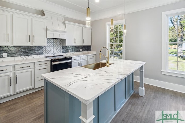 kitchen with stainless steel electric range, a kitchen island with sink, decorative light fixtures, and white cabinetry