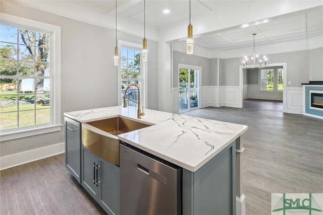 kitchen featuring a sink, open floor plan, plenty of natural light, and dishwasher