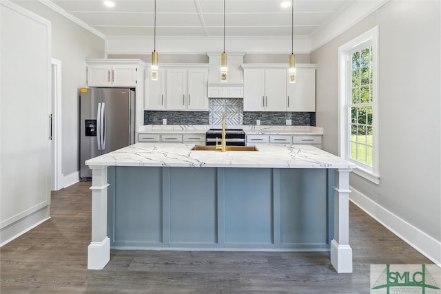 kitchen featuring a spacious island, stainless steel appliances, plenty of natural light, and white cabinetry