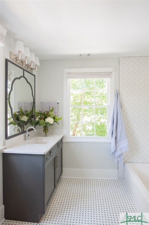 bathroom with vanity and a bathtub