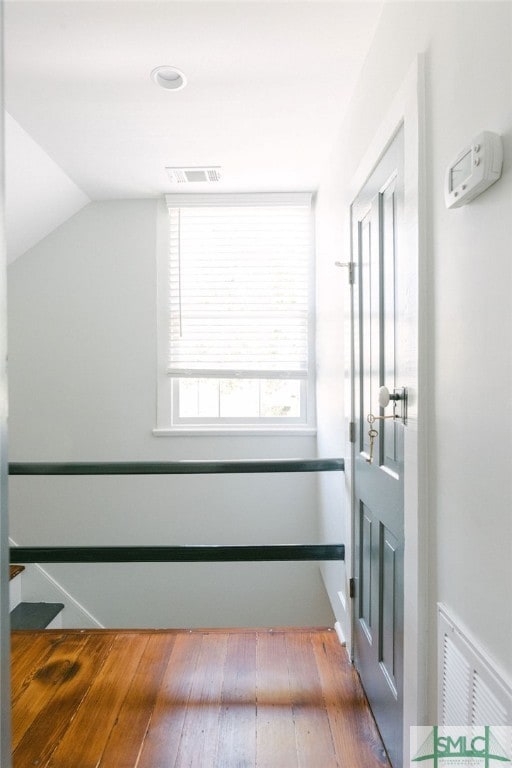 interior space featuring lofted ceiling and wood-type flooring