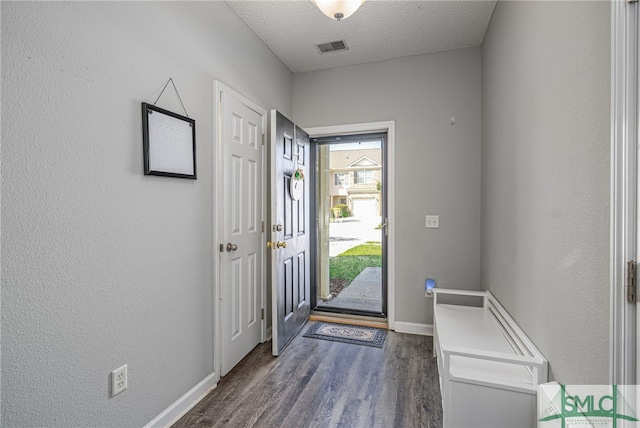 entrance foyer featuring dark hardwood / wood-style flooring and a textured ceiling