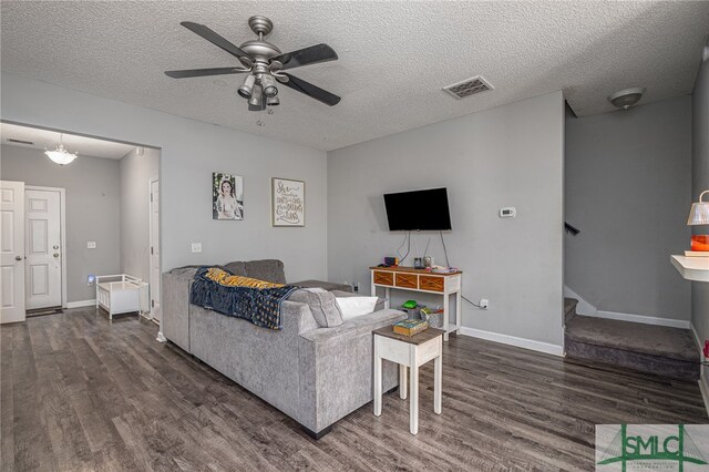 1030 Canyon Oak Loop, Richmond Hill, GA 31324 - living room featuring wood finished floors, ceiling fan, stairs, baseboards, and a textured ceiling