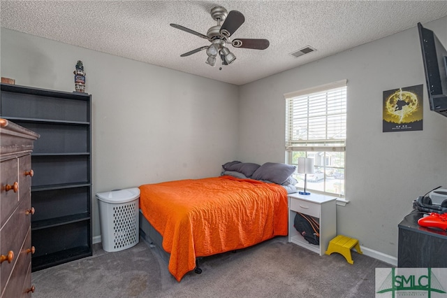 carpeted bedroom with a textured ceiling and ceiling fan