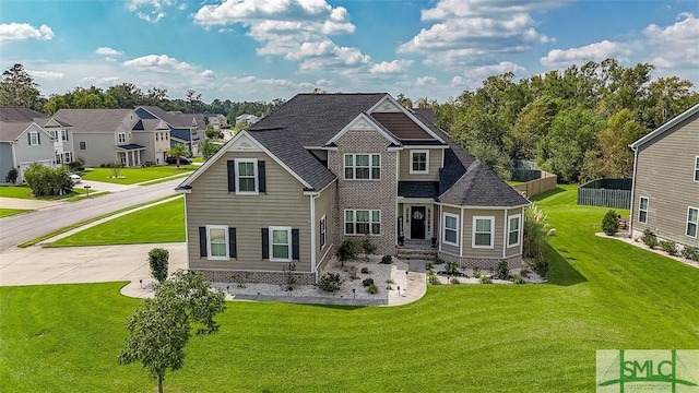 view of front of house featuring fence, driveway, roof with shingles, a residential view, and a front lawn