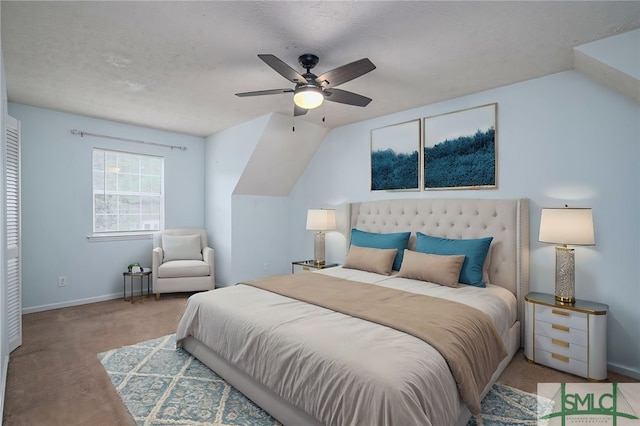 bedroom with ceiling fan, a textured ceiling, vaulted ceiling, and light colored carpet