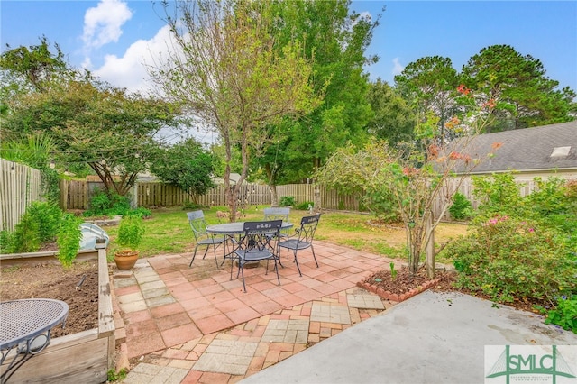 view of patio with outdoor dining area and a fenced backyard