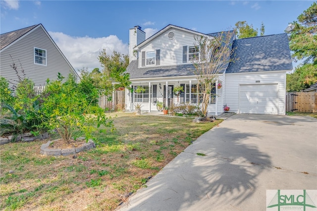 traditional home with fence, a garage, a chimney, covered porch, and driveway