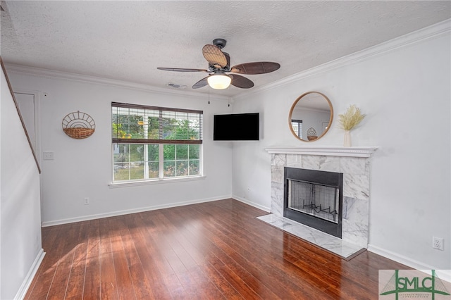 unfurnished living room with a fireplace, a textured ceiling, dark hardwood / wood-style flooring, ceiling fan, and crown molding