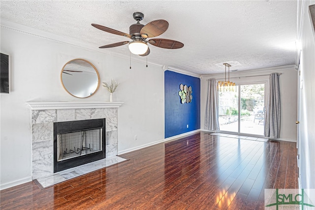 unfurnished living room with ceiling fan, a fireplace, a textured ceiling, and wood finished floors