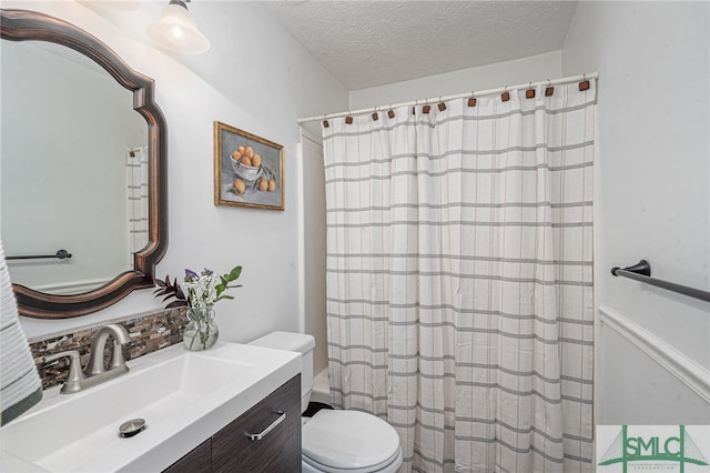 bathroom with vanity, a textured ceiling, a shower with curtain, and toilet