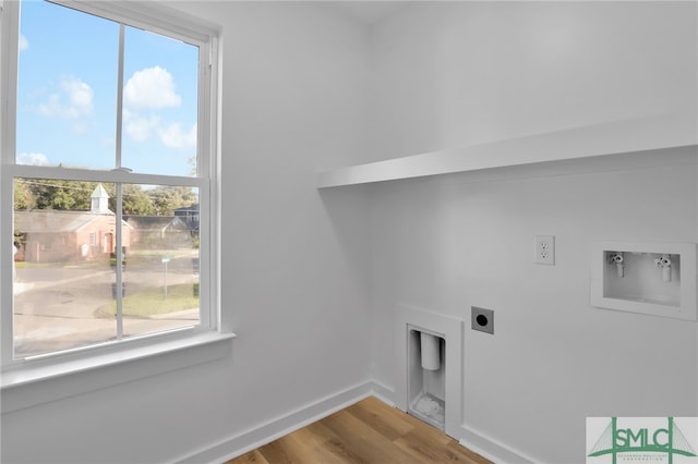 washroom featuring electric dryer hookup, hookup for a washing machine, and hardwood / wood-style floors