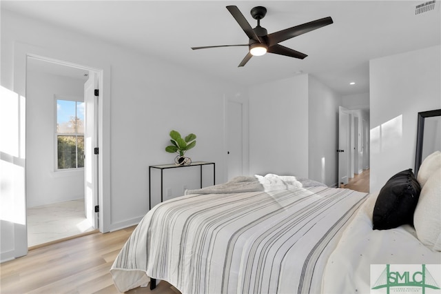 bedroom with light hardwood / wood-style floors and ceiling fan