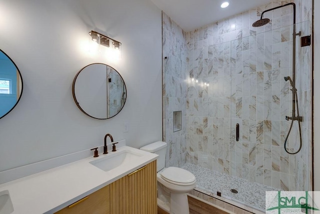 bathroom featuring hardwood / wood-style flooring, vanity, toilet, and walk in shower