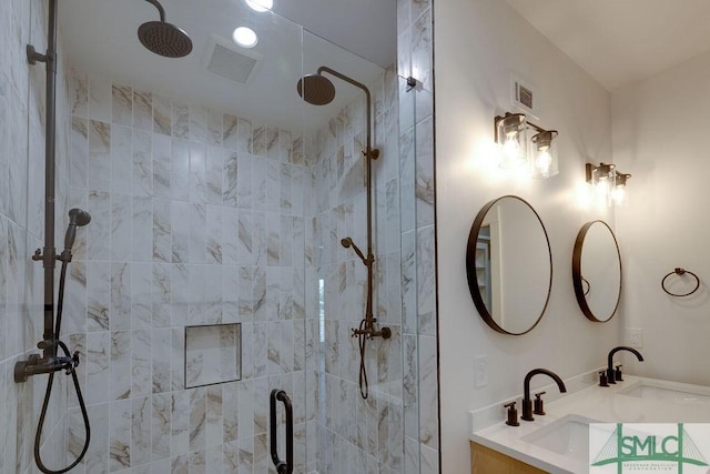 bathroom featuring vanity and an enclosed shower