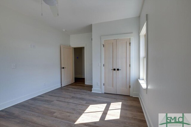 unfurnished bedroom featuring ceiling fan, a closet, and light hardwood / wood-style floors