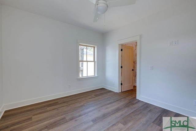 spare room with ceiling fan and wood-type flooring