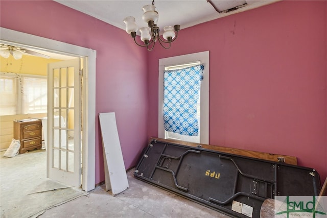 misc room with ceiling fan with notable chandelier