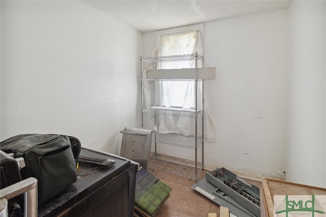 laundry area featuring wood-type flooring