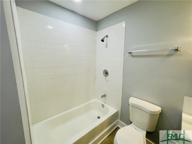 bathroom featuring tiled shower / bath and toilet