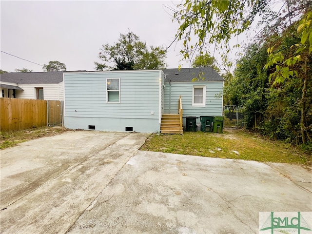 back of property featuring a patio area and a lawn