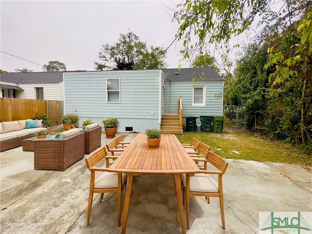 rear view of house with an outdoor living space and a patio area