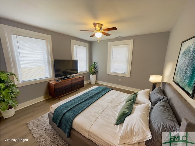 bedroom with hardwood / wood-style flooring and ceiling fan