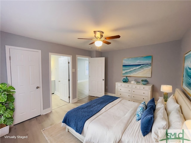 bedroom featuring connected bathroom, light wood-type flooring, and ceiling fan