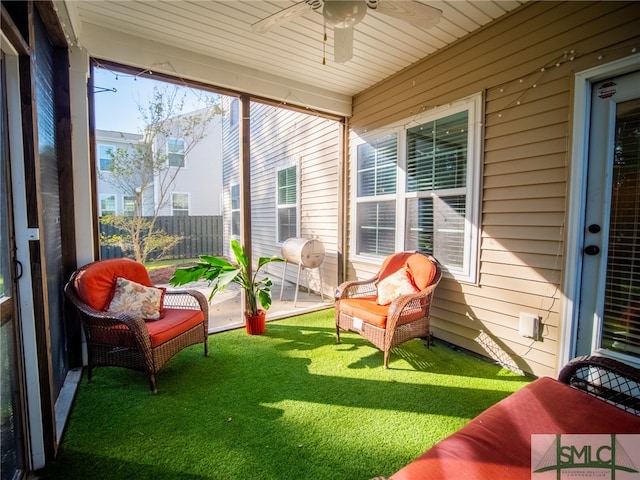 sunroom with ceiling fan and a healthy amount of sunlight