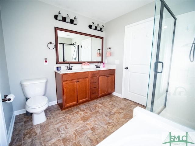 bathroom featuring vanity, toilet, and an enclosed shower