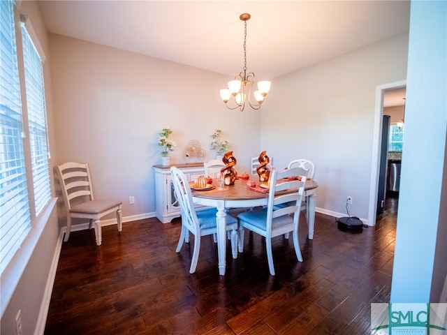 dining room with plenty of natural light, dark wood-type flooring, and an inviting chandelier