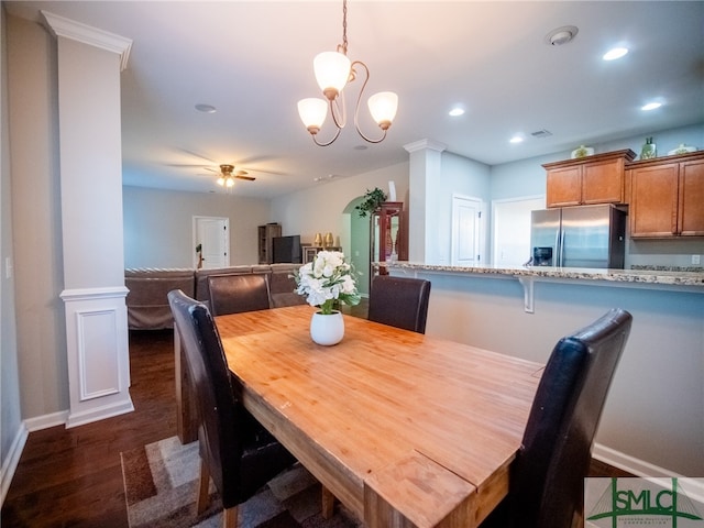 dining room with dark hardwood / wood-style floors and ceiling fan with notable chandelier