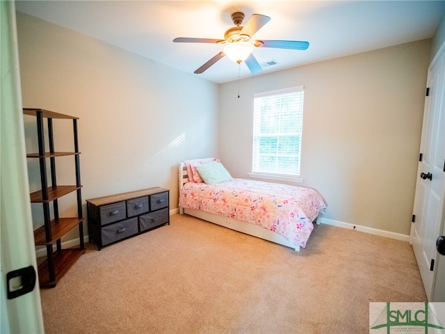 bedroom featuring ceiling fan and light carpet