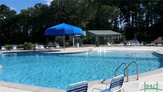 view of swimming pool with a patio