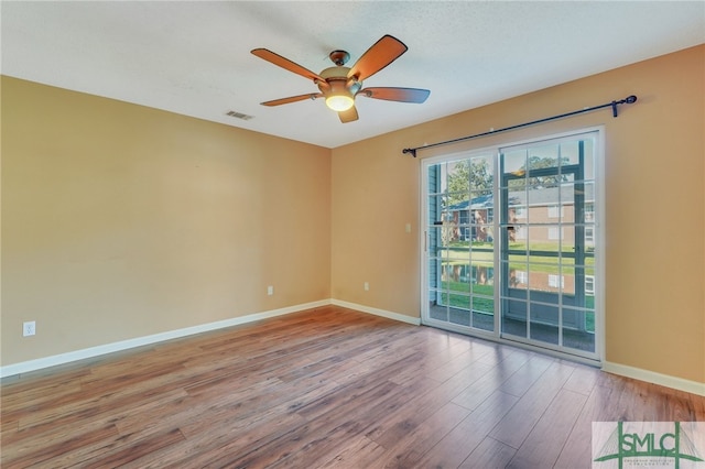 spare room with ceiling fan and hardwood / wood-style flooring