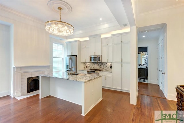 kitchen featuring appliances with stainless steel finishes, white cabinetry, and dark wood-type flooring