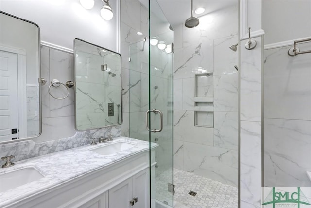 bathroom featuring vanity and a shower with door